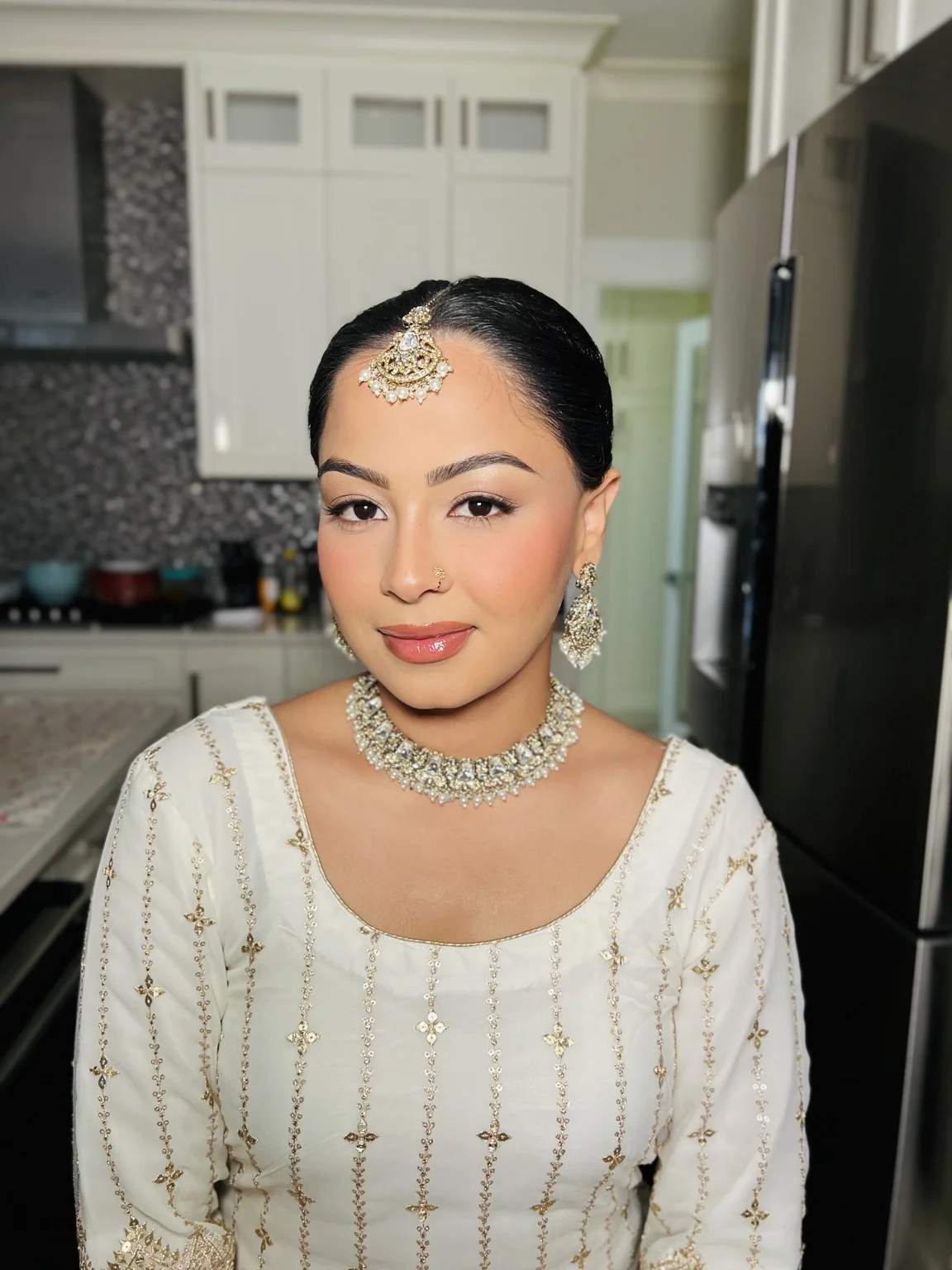 Soft glam makeup and sleek bridal styling